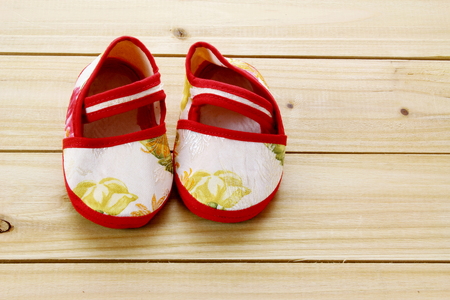 Baby Shoes on Wooden Backgroundの写真素材