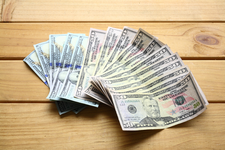 Bank Notes on Wooden Backgroundの写真素材