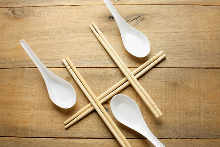 Chopsticks and Spoons on Wooden Backgroundの写真素材