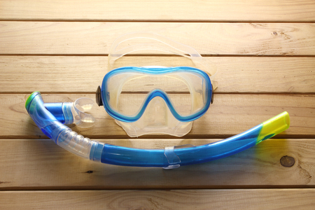 Goggles and Snorkel on Wooden Backgroundの写真素材