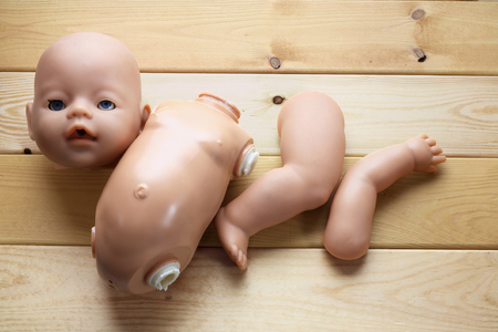 Broken Doll on Wooden Backgroundの写真素材
