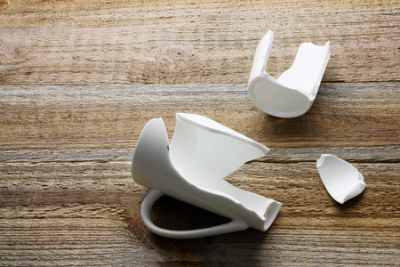 Broken Coffee Cup on Wooden Backgroundの写真素材