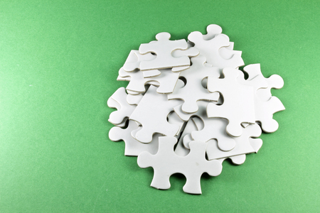 Jigsaw Puzzle Pieces on Green Backgroundの写真素材