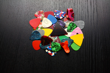 Guitar Plectrums on Wooden Backgroundの写真素材