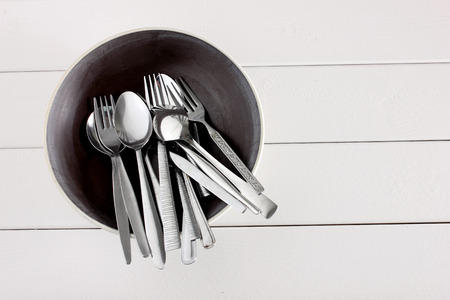 Forks and Spoons on Wooden Background
