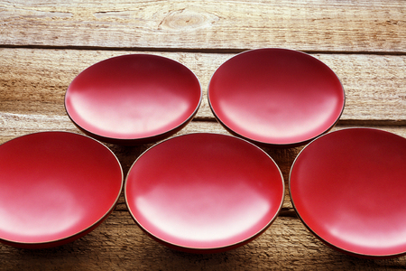 Red Dishes on Wooden Backgroundの写真素材