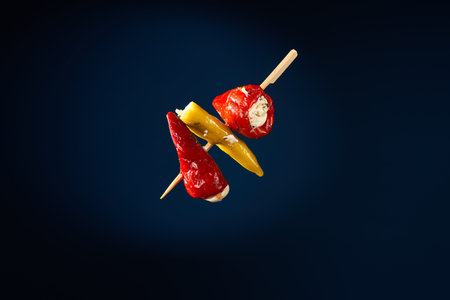 Finger food sticks with olives stuffed pepperoni.