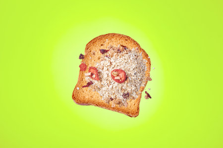 Sweet bread with oatmeal and dried fruits on green background.の写真素材