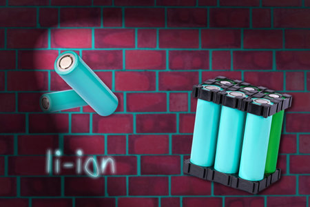 Lithium battery pack floating in the air on the background of red brick wall.の写真素材