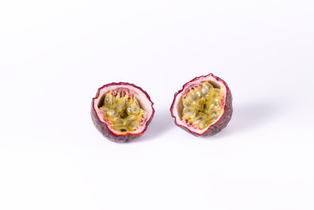 Passion fruit cut in half on white background.