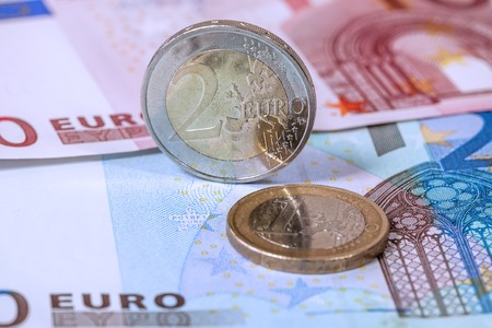 Many euro banknotes and coins, closeup shot