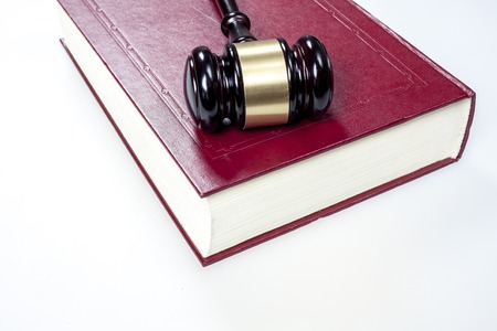 The hammer of the judge and the book on a white backgroundの写真素材