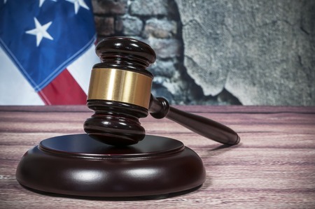 Gavel and USA flag on the background of the old wallの写真素材