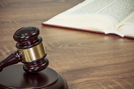 Judge gavel and old books on a wooden tableの写真素材