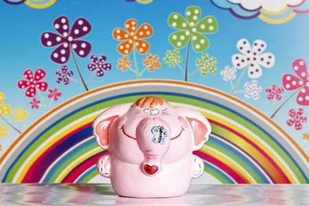 Funny elephant on a rainbow background and colorful flowersの写真素材