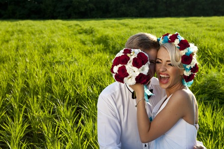 a Happy bride and groom on the bright green fieldの写真素材