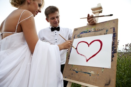 the bride and groom paint on an easel emotion smile laughの写真素材