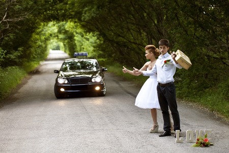 a Beautiful bride and groom, the road auto-stopの写真素材