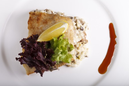 a salad greens in a white plate on a black backgroundの写真素材