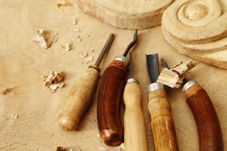 Vintage tools of woodcarving closeup on wooden backgroundの写真素材