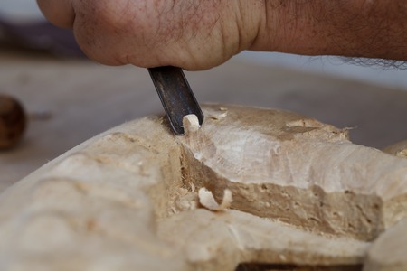 a wood carvings, tools and processes work closeup