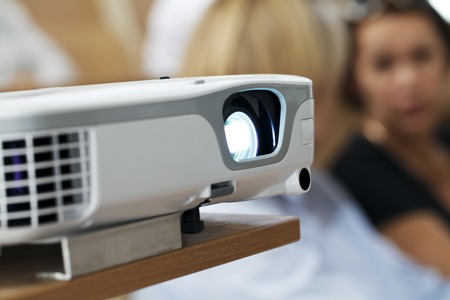 digital projector at the presentation close-up on the foreground, blurred backgroundの写真素材