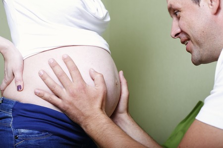 a Pregnant happy young parents waiting for baby's birthの写真素材
