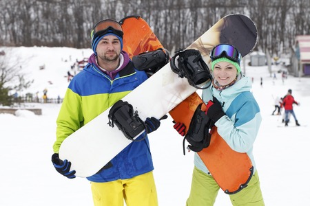 young couple snowboarders rejoice and be gladの写真素材