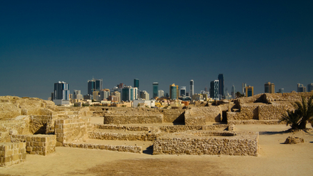 Ruins of Qalat fort and Manama in Bahrainの写真素材