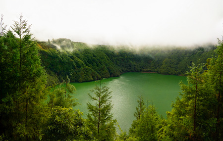 Aerial view to Lagoa de Santiago at fog at Sao Muel, Azores, Portugalの写真素材