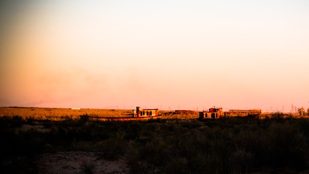 Panorama of ship cemetery at sunset near Moynaq at Karakalpakstan, Uzbekistanの写真素材