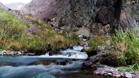 Small waterfall to Too-Ashuu pass and Kara Balta river and valley at Chuy Region of Kyrgyzstan