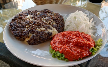 Traditional serbian and balkan dish Pljeskavica with sauce in Maribor,Sloveniaの写真素材
