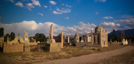 Panorama view to muslim cemetery Semiz Bel at sunset at Kochkor in Naryn region , Kyrgyzstan
