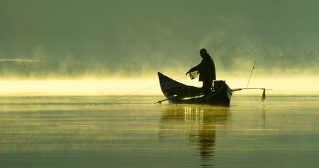 Fishing in the late evening on a boat.の写真素材
