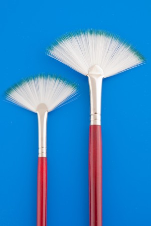 Art brushes on bright blue background.の写真素材