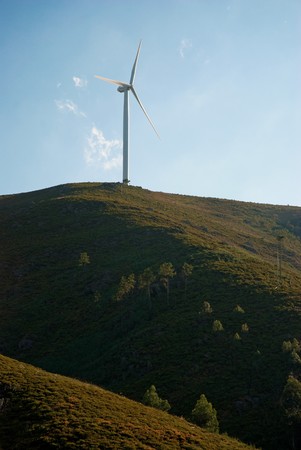 Wind turbine on a hill generating electricity.の写真素材