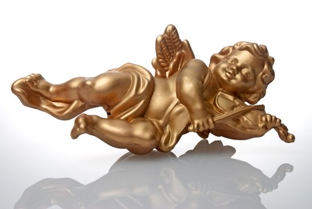 Angel plastic statue of an gold angel playing violin with reflection on white background.の写真素材