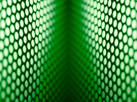 A metalic reflective surface back lit by a colorful light.