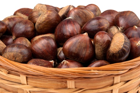 Wicker basket with chestnuts isolated on white background.の写真素材