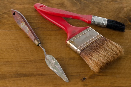 Closeup of clean used Art brushes and spatula on wooden background.