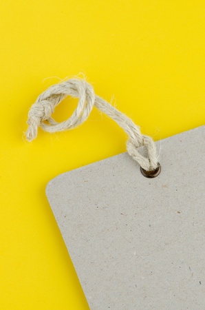 Closeup of blank product info label on yellow background.