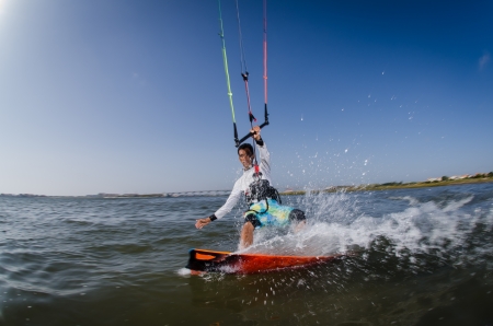 Kiteboarder enjoy surfing on a sunny day.