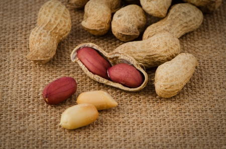 Peanuts on old raffia background.