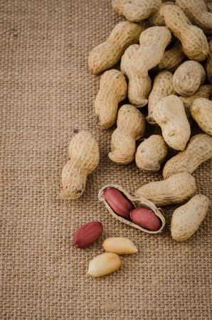 Peanuts on old raffia background の写真素材