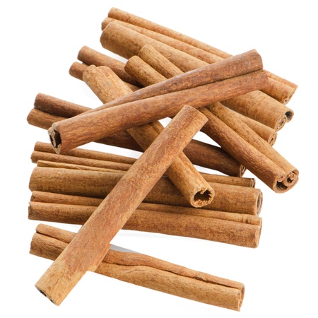 Cinnamon sticks on white reflective background の写真素材