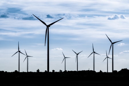 Backlit view of a group of mills for electric power generationの写真素材
