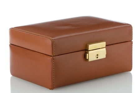 Brown leather jewlery box on white reflective background.の写真素材