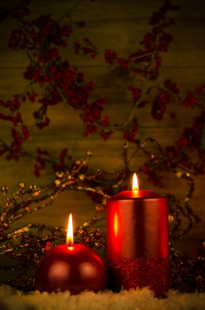 Two candles decorated in a festive Christmas decoration.の写真素材