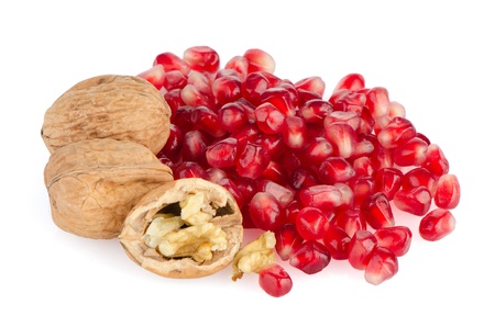 Pomegranate seed pile and nuts isolated on white background の写真素材